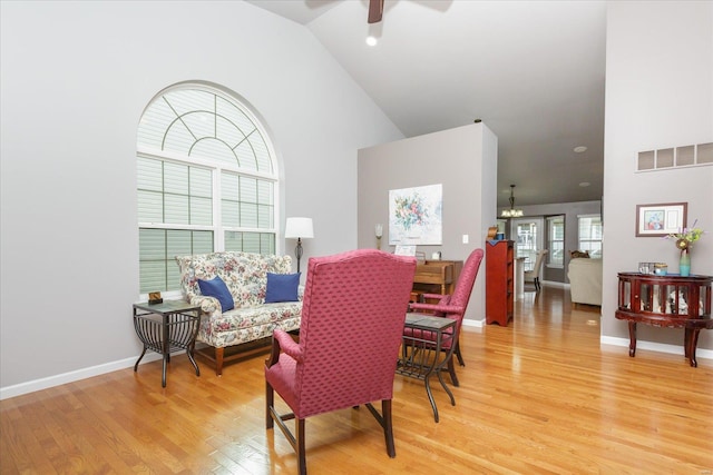 dining room featuring wood-type flooring, ceiling fan, and high vaulted ceiling