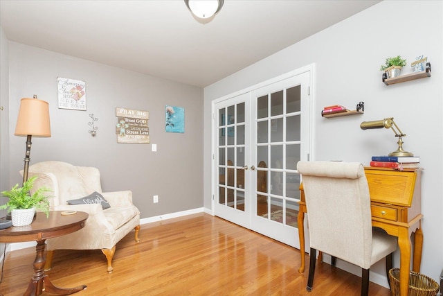 sitting room with french doors and hardwood / wood-style flooring