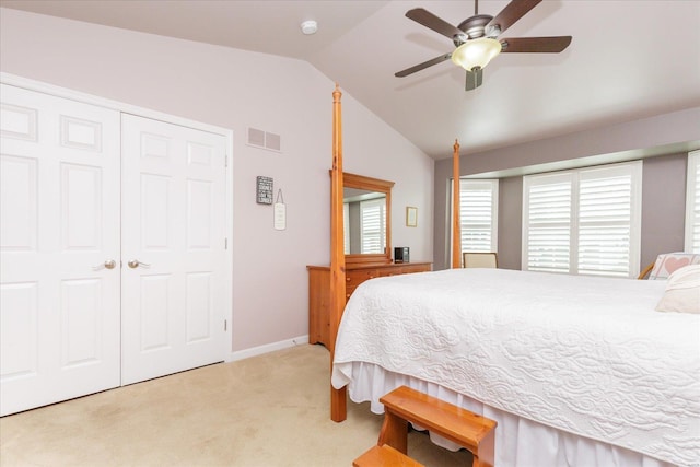 carpeted bedroom featuring vaulted ceiling, ceiling fan, and a closet