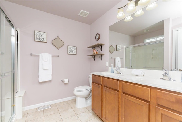 bathroom featuring a shower with door, vanity, tile patterned floors, and toilet