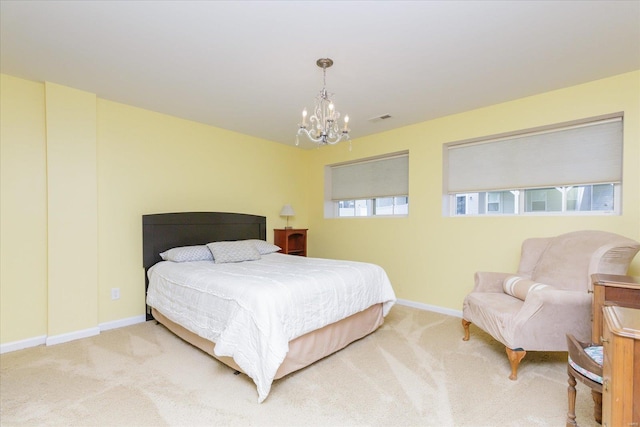 bedroom featuring a chandelier and carpet flooring