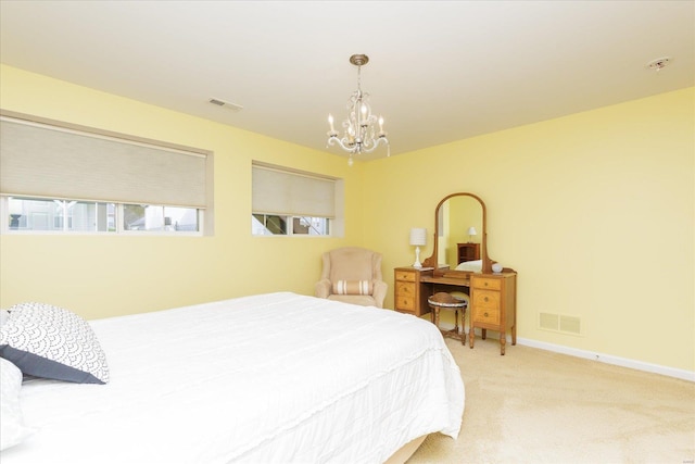 carpeted bedroom featuring a notable chandelier