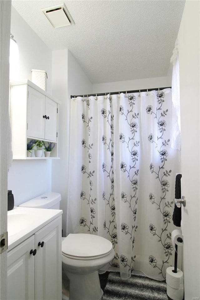 bathroom with vanity, a textured ceiling, toilet, and a shower with shower curtain