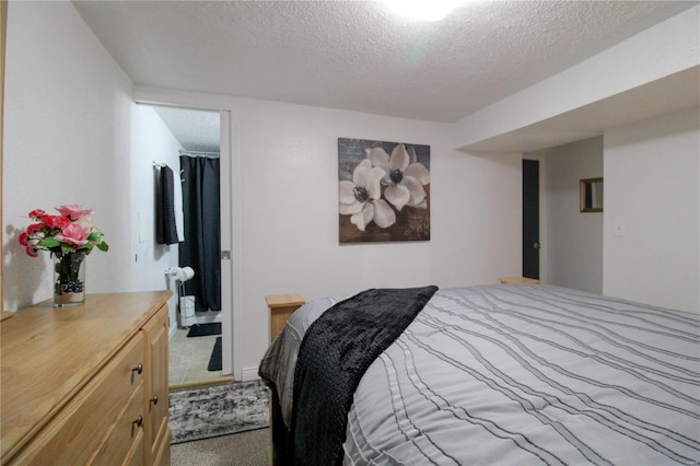 carpeted bedroom featuring a textured ceiling