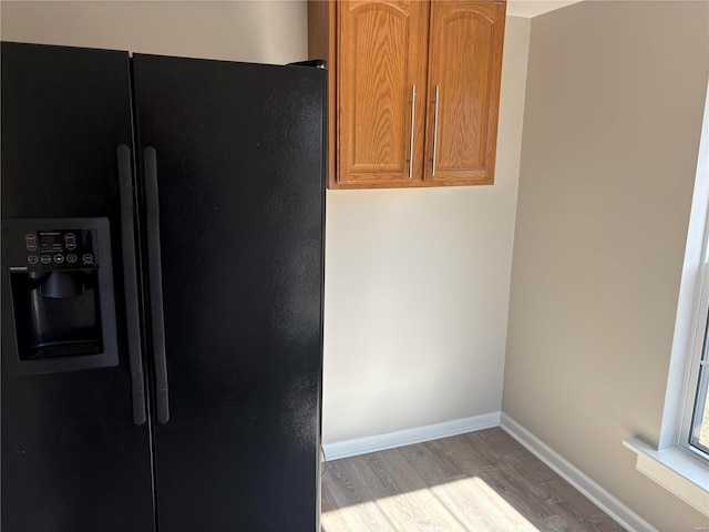 kitchen featuring black fridge and light wood-type flooring