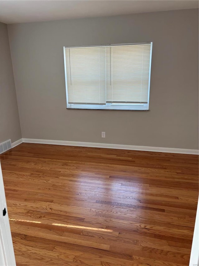 empty room featuring wood-type flooring