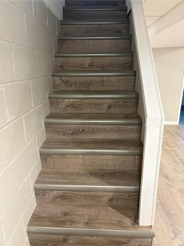 stairs featuring wood-type flooring