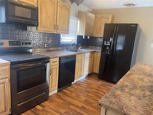 kitchen with dark hardwood / wood-style floors, light brown cabinetry, sink, backsplash, and black appliances