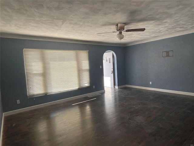 spare room featuring dark hardwood / wood-style floors, a textured ceiling, and ceiling fan