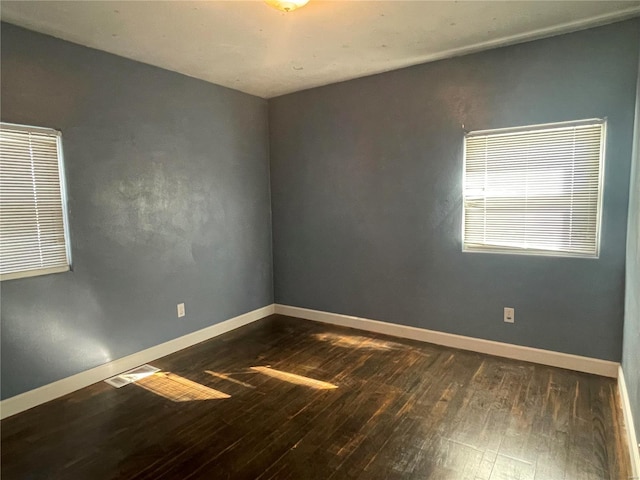 spare room with dark hardwood / wood-style flooring