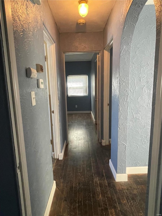 hallway with dark wood-type flooring