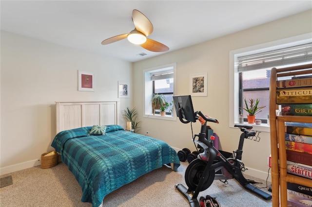 carpeted bedroom featuring visible vents, ceiling fan, and baseboards