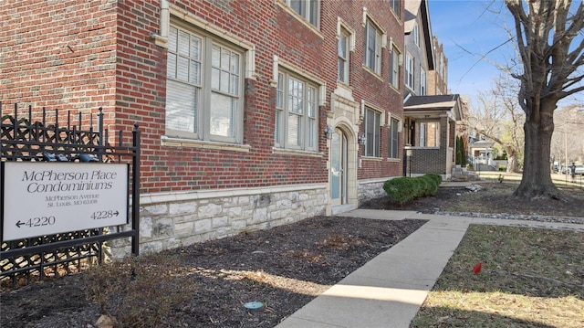 view of side of home with brick siding