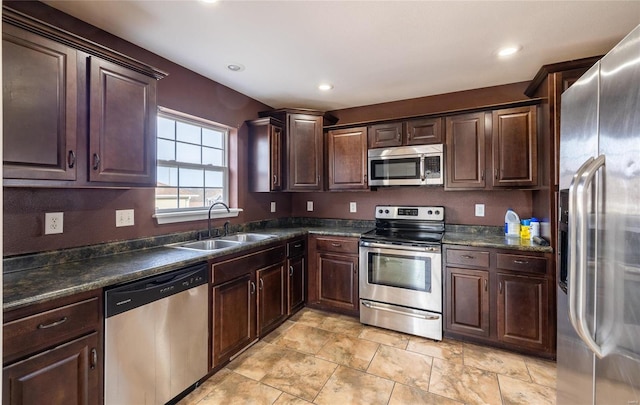 kitchen with stainless steel appliances, sink, and dark brown cabinetry