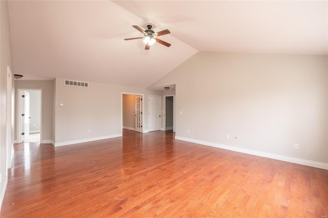 empty room featuring lofted ceiling, hardwood / wood-style floors, and ceiling fan