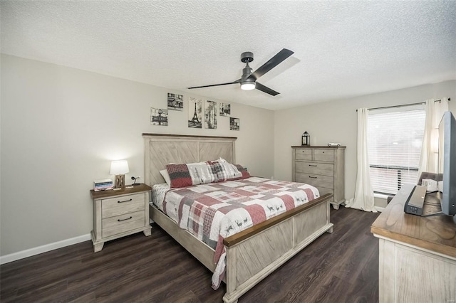 bedroom with ceiling fan, dark hardwood / wood-style floors, and a textured ceiling