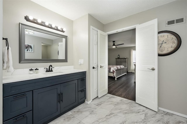 bathroom with vanity and a textured ceiling