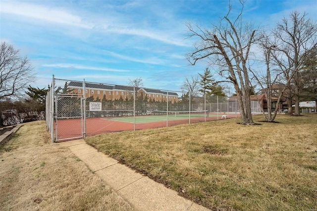 view of sport court featuring a lawn