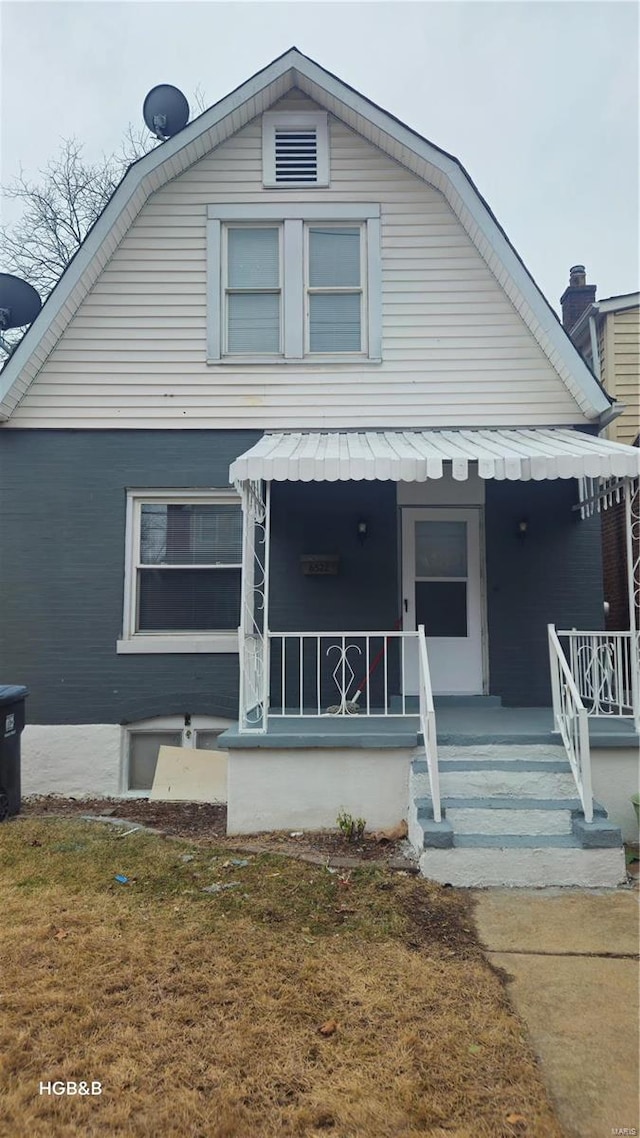 view of front of home with a porch and a front yard