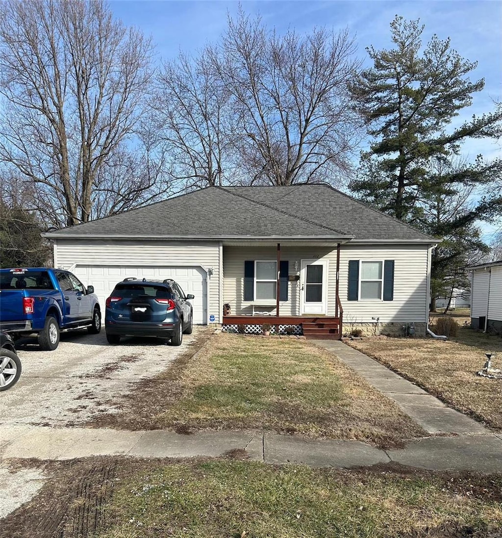 single story home with a garage and a front lawn