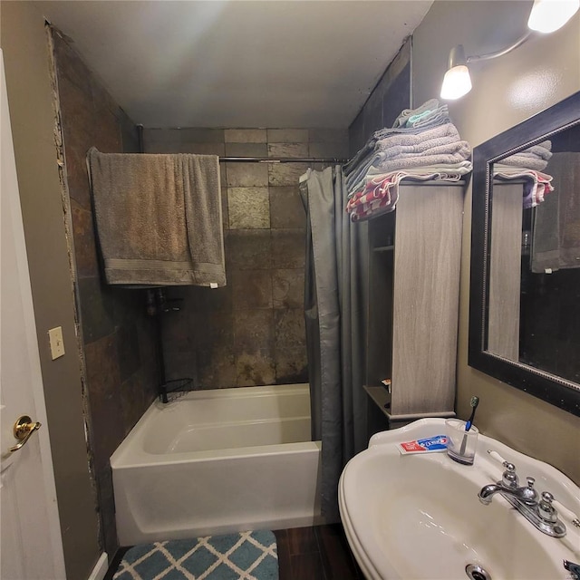 bathroom featuring sink and shower / tub combo with curtain