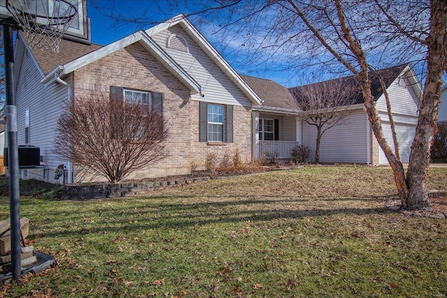 view of front of house with central AC, a garage, and a front yard