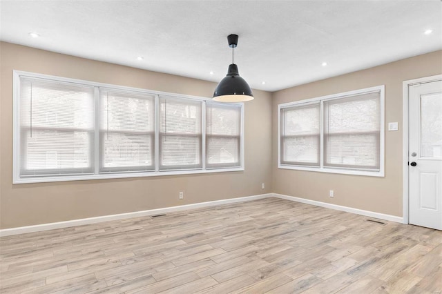 unfurnished dining area featuring light hardwood / wood-style flooring