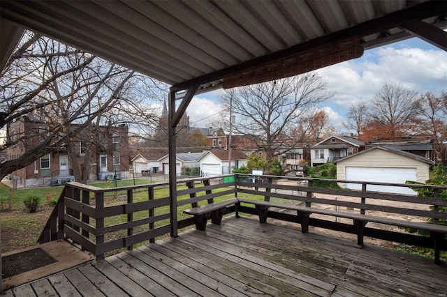 wooden deck featuring an outbuilding and a garage