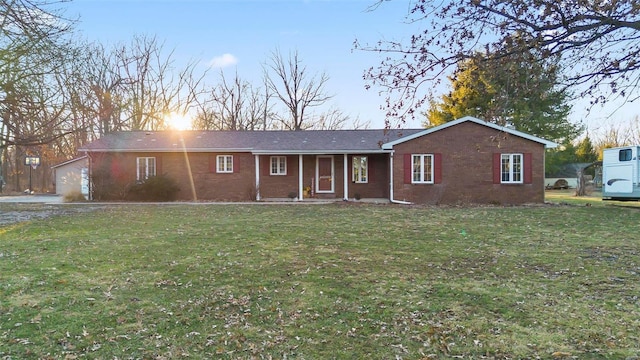 ranch-style home with a yard