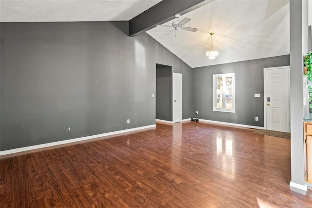 unfurnished room with vaulted ceiling with beams, wood finished floors, and baseboards