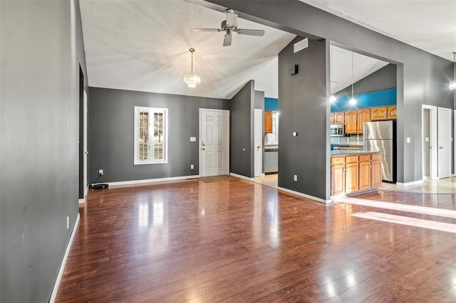 unfurnished living room featuring light wood-style floors, visible vents, baseboards, and ceiling fan with notable chandelier