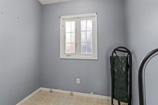 spare room with baseboards