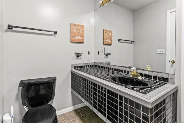 bathroom with toilet, tile patterned flooring, vanity, and baseboards