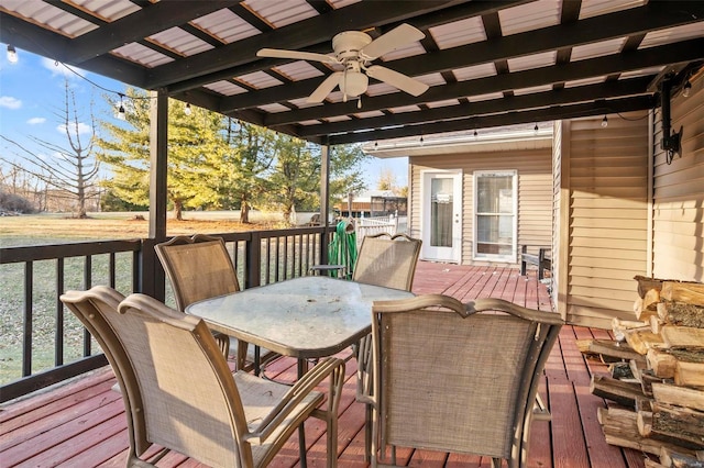 wooden terrace featuring a ceiling fan and outdoor dining space