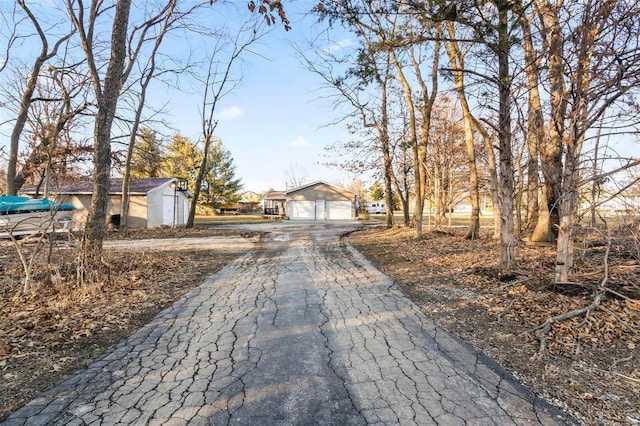 view of front of house with a garage and an outdoor structure