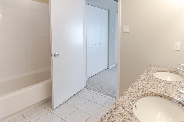 bathroom with tiled shower / bath, vanity, and tile patterned flooring