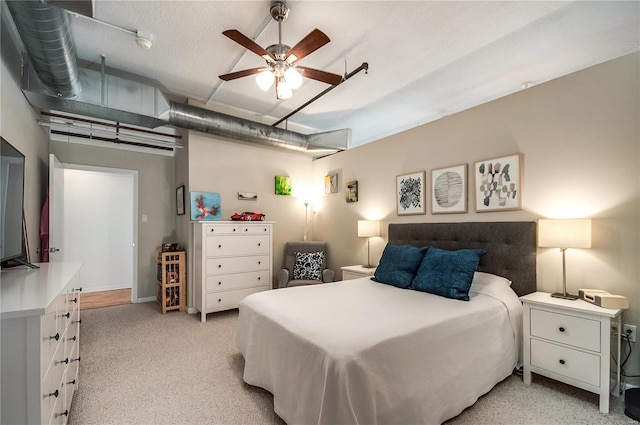 bedroom featuring light colored carpet and ceiling fan