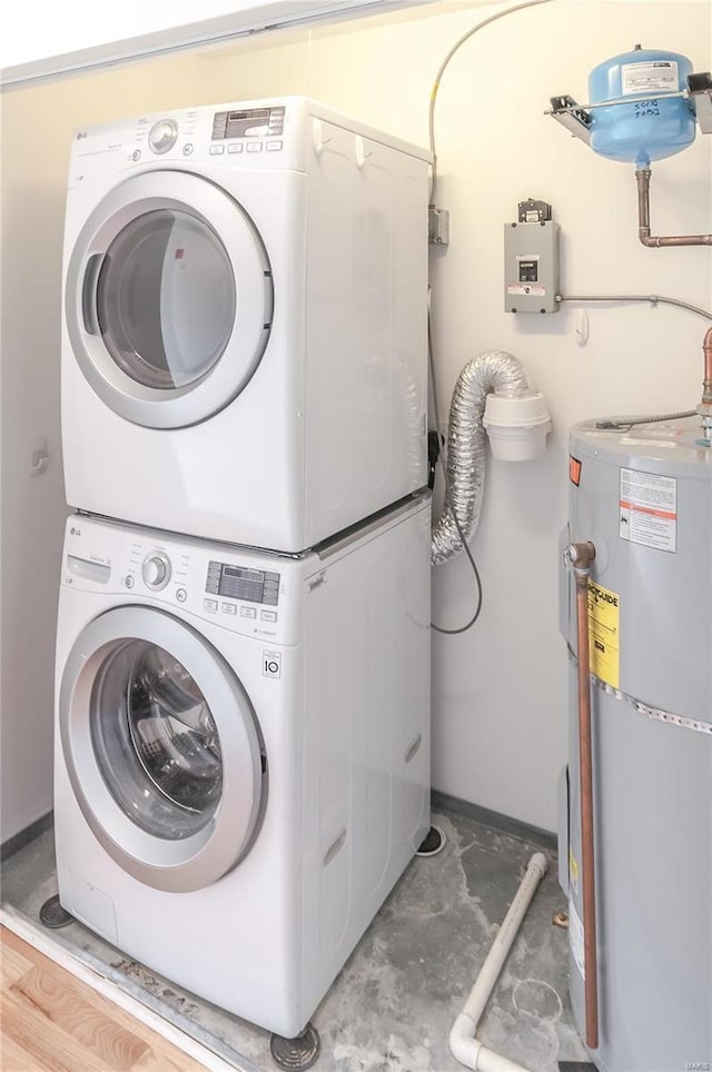 laundry room with stacked washer / drying machine and electric water heater