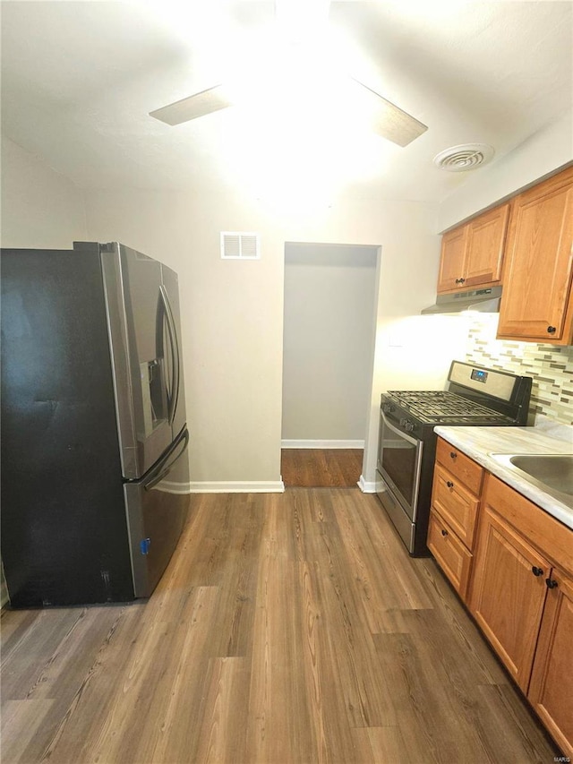 kitchen with backsplash, dark wood-type flooring, stainless steel appliances, and sink