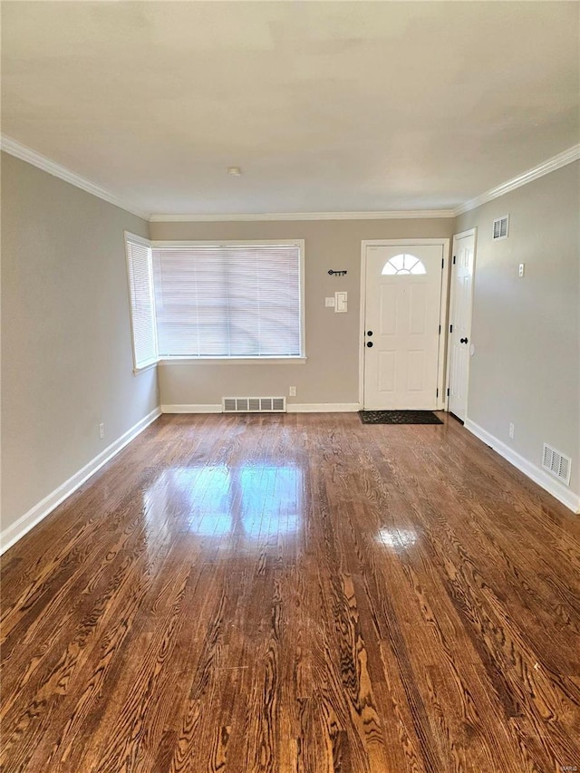 foyer entrance featuring hardwood / wood-style flooring and crown molding