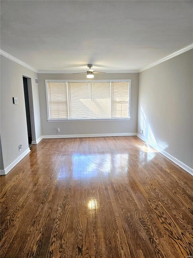 empty room featuring crown molding, hardwood / wood-style floors, and ceiling fan