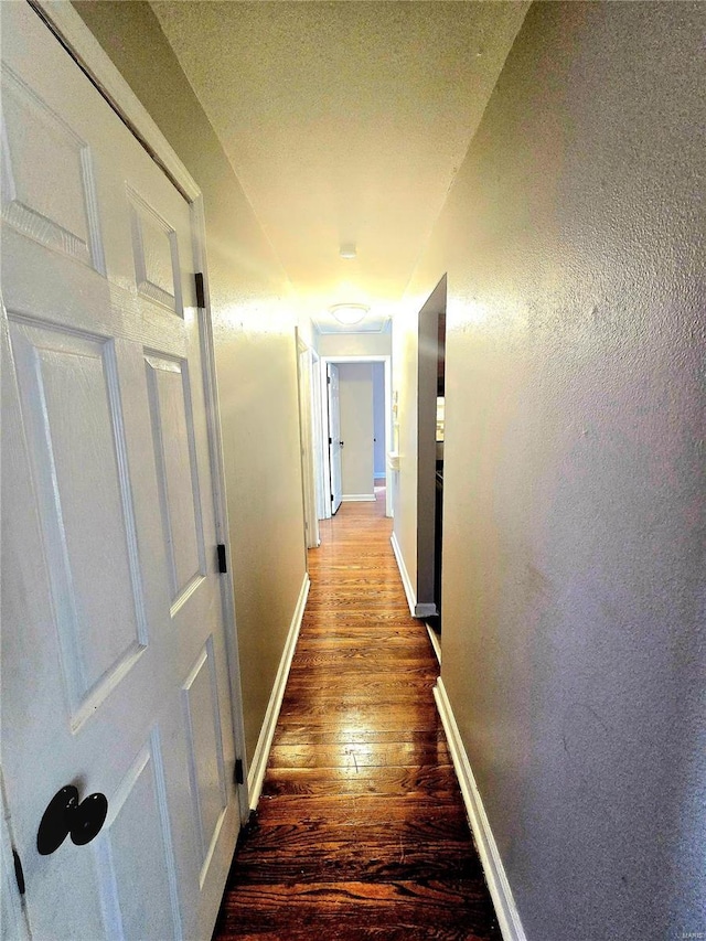 hall with dark hardwood / wood-style floors