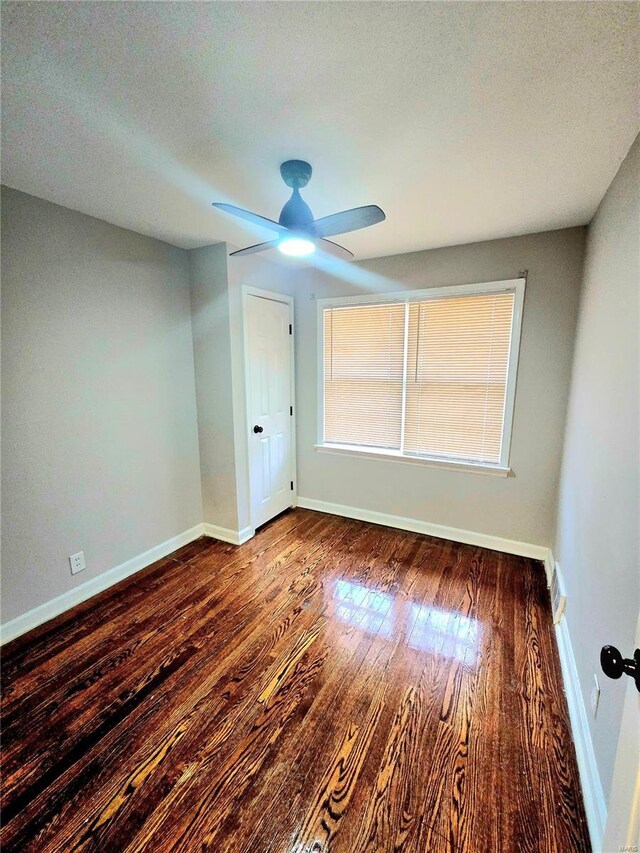 spare room with ceiling fan, dark hardwood / wood-style floors, and a textured ceiling