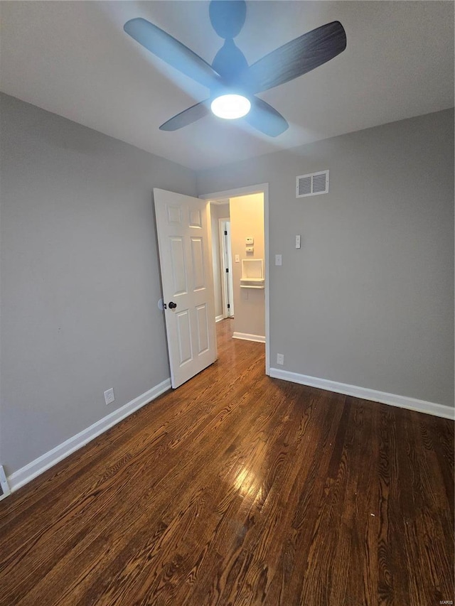 unfurnished bedroom featuring dark hardwood / wood-style floors and ceiling fan