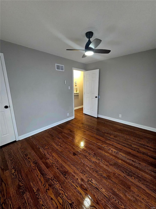 unfurnished bedroom with dark wood-type flooring and ceiling fan