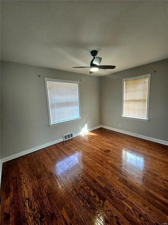 unfurnished room with a textured ceiling, wood-type flooring, and ceiling fan