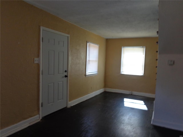 foyer entrance with dark hardwood / wood-style floors