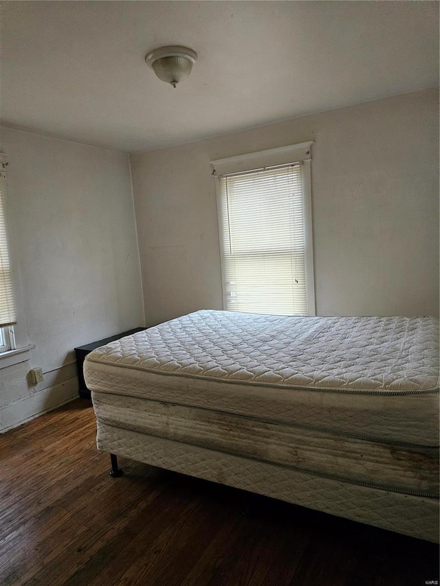 unfurnished bedroom with dark hardwood / wood-style flooring