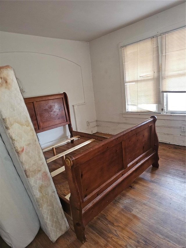 bedroom with dark hardwood / wood-style flooring