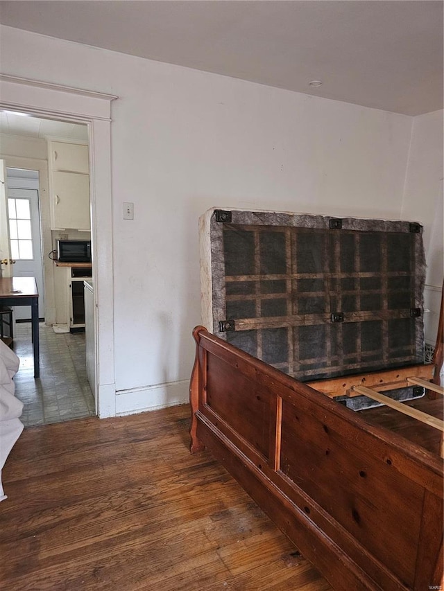 interior space featuring black microwave and hardwood / wood-style floors